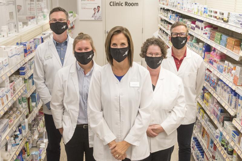 Pharmacists wearing face masks